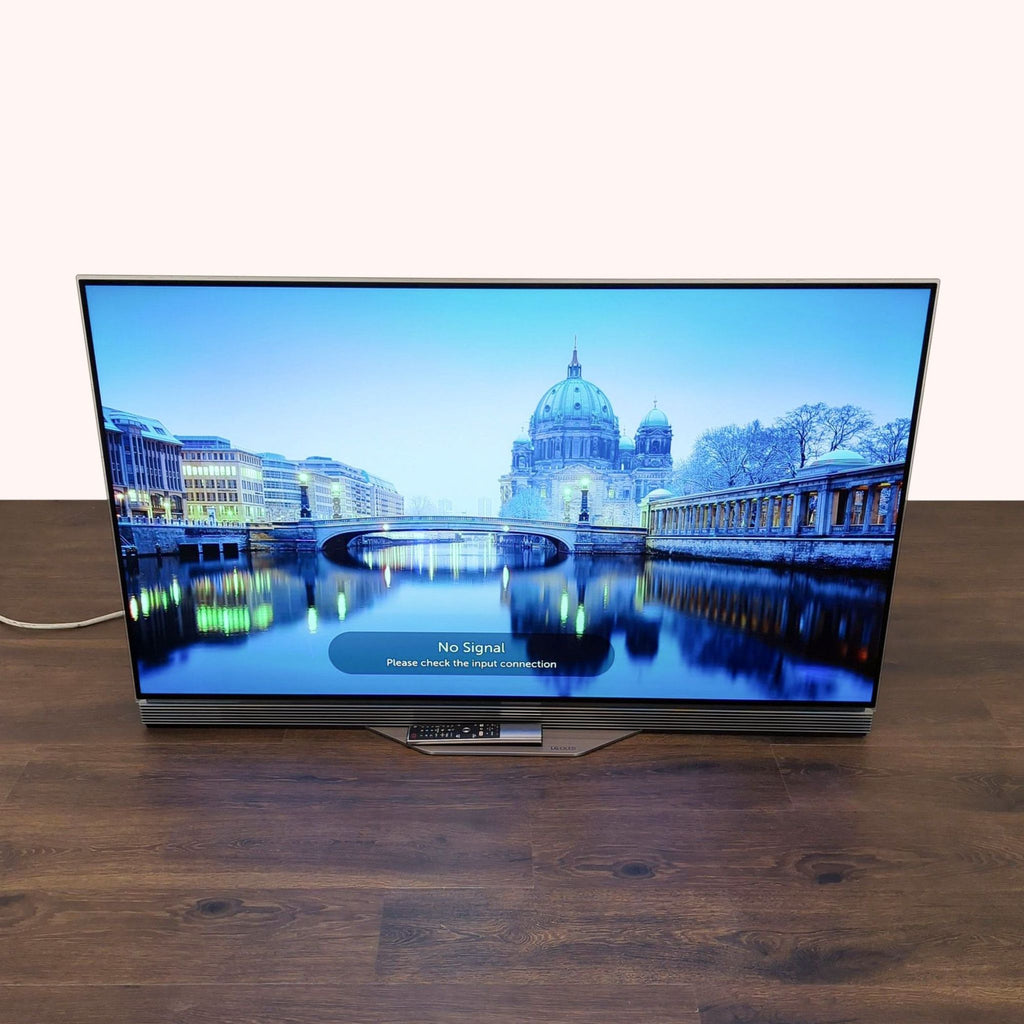 2. LG OLED TV displaying cityscape with "No Signal" message, featuring sleek design and visible soundbar base.