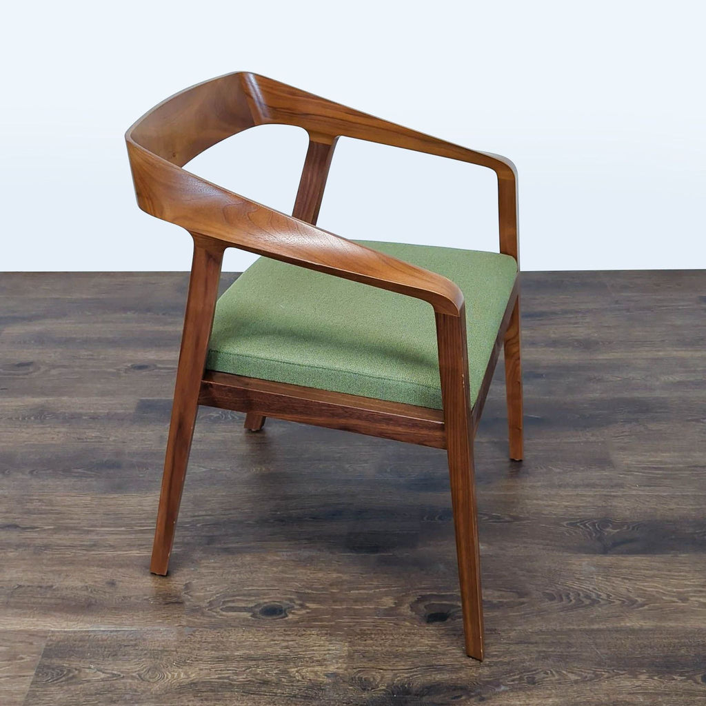 2. Side angle of a Reperch wooden chair featuring a modern design and green cushioned seat.  