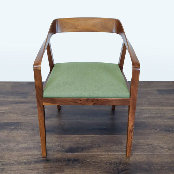 1. Wooden chair by Reperch with a curved backrest and green cushioned seat, shown from the front.  