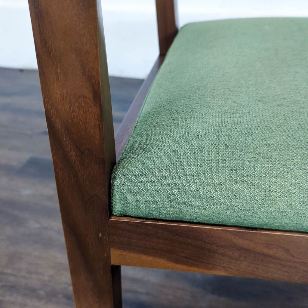 3. Close-up of the green fabric seat and wooden frame of a Reperch chair, showing material detail.