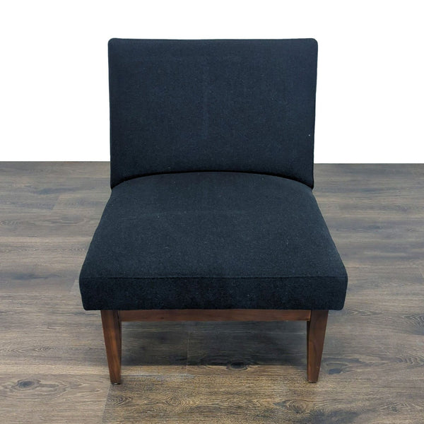 1. Lounge chair with a solid walnut frame and easel-back, upholstered in black fabric, front view.