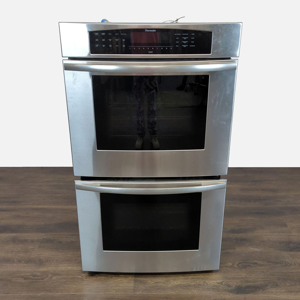 Thermador 30-inch stainless steel double wall oven with digital controls and two large glass doors, seen front view.  