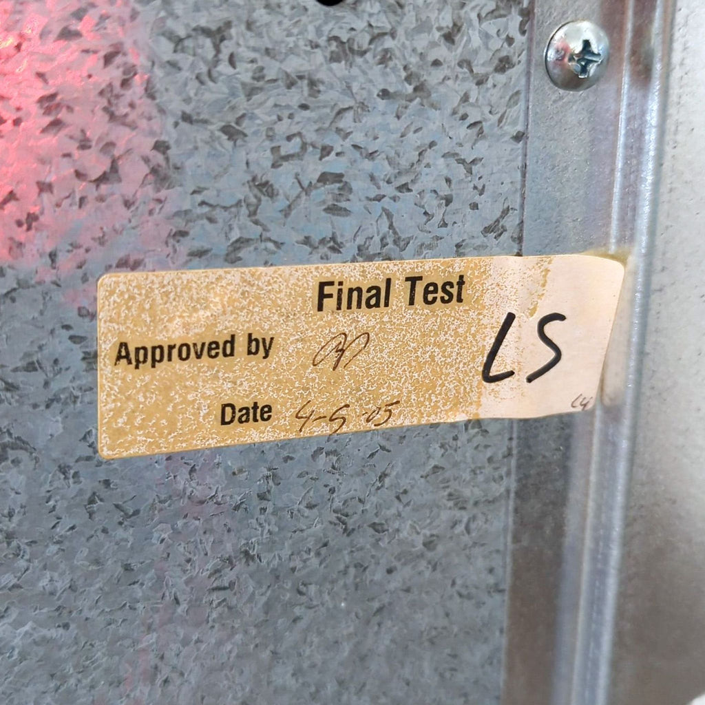 Close-up of a "Final Test" inspection sticker on galvanized metal, shows approval initials and handwritten date.
