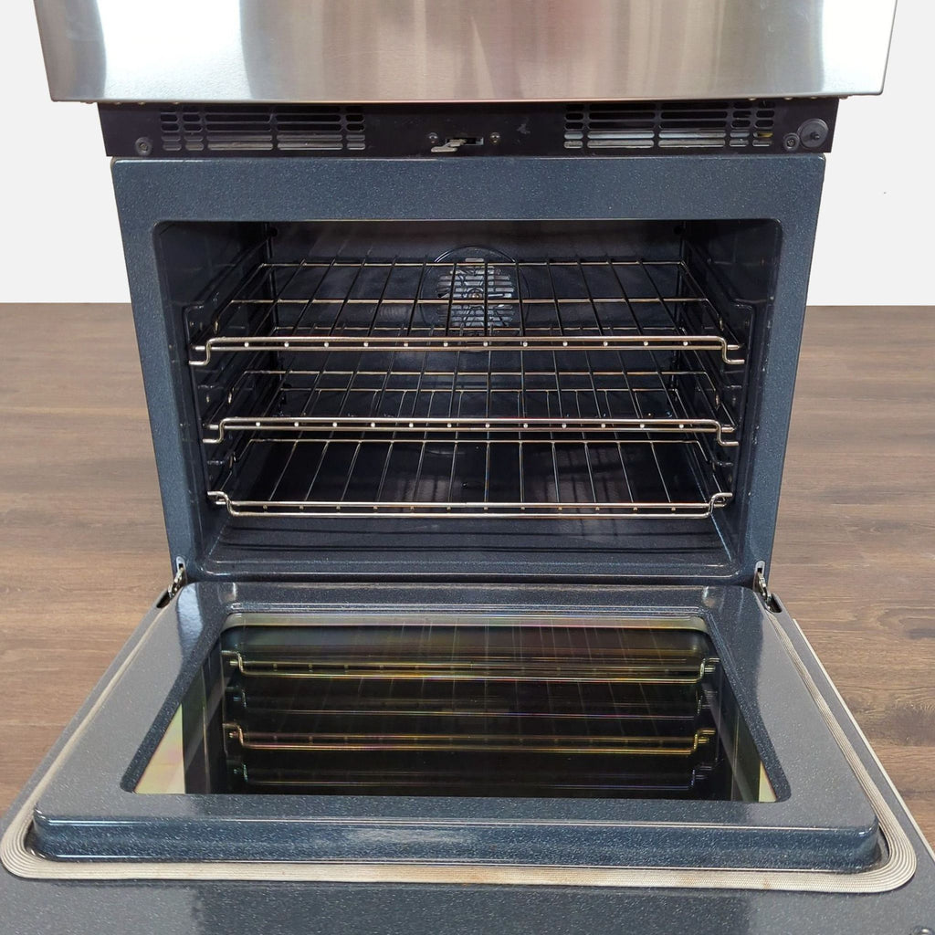 Open view of the Thermador C302BS oven's spacious interior with multiple racks and blue porcelain finish.  