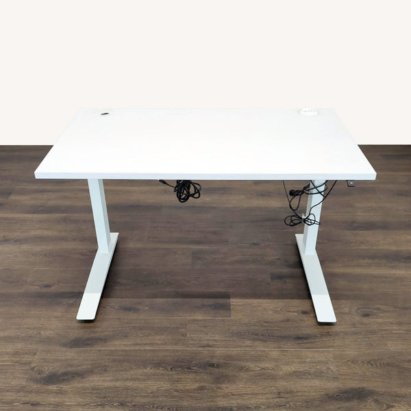 1. White Fully desk with cord management, power grommet, and up/down handset, shown on a wooden floor.  