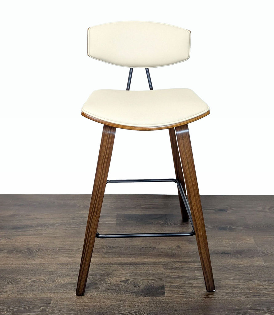 1. Mid-Century Armen Living stool with wooden legs and cream faux leather seat and backrest shown from the front.