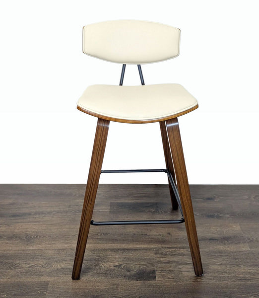 1. Mid-Century Armen Living stool with wooden legs and cream faux leather seat and backrest shown from the front.