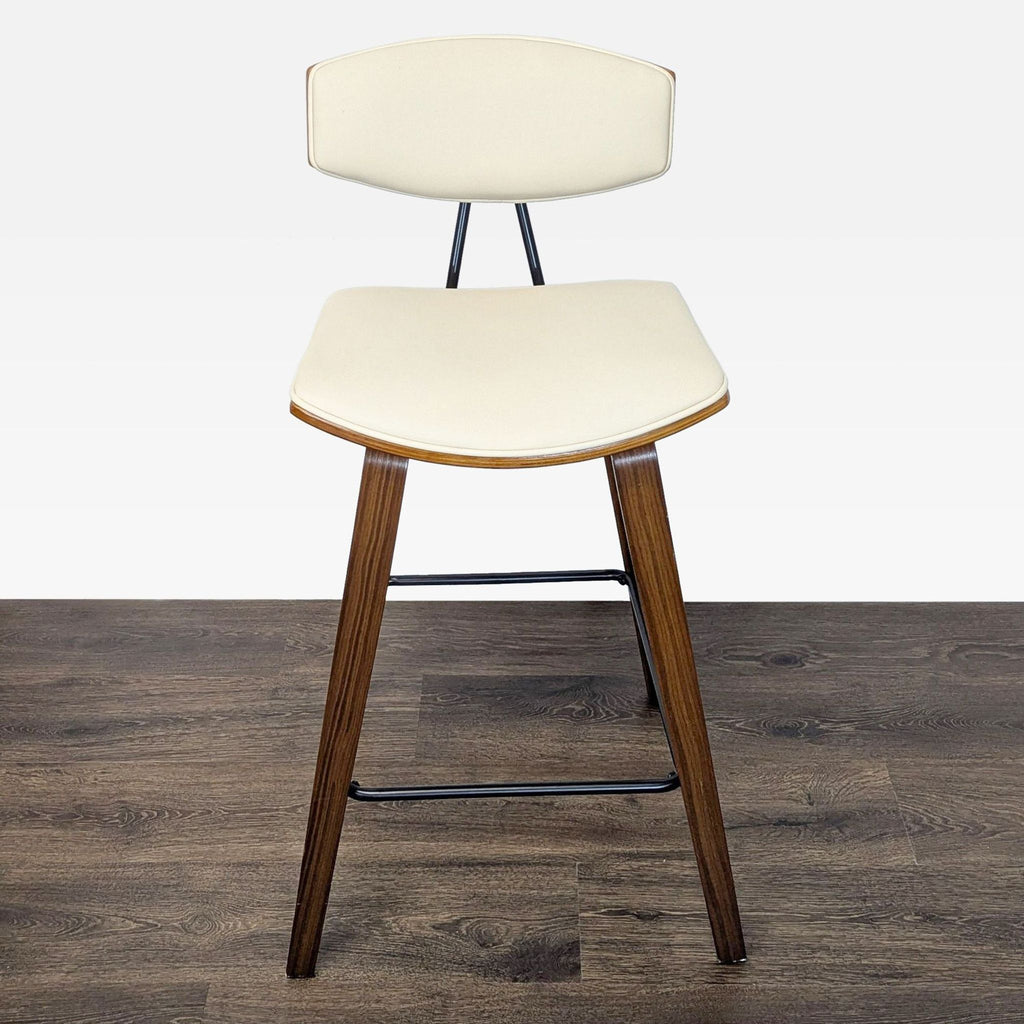 3. Angle view of a Mid-Century style Armen Living stool with wooden frame and cream faux leather upholstery.