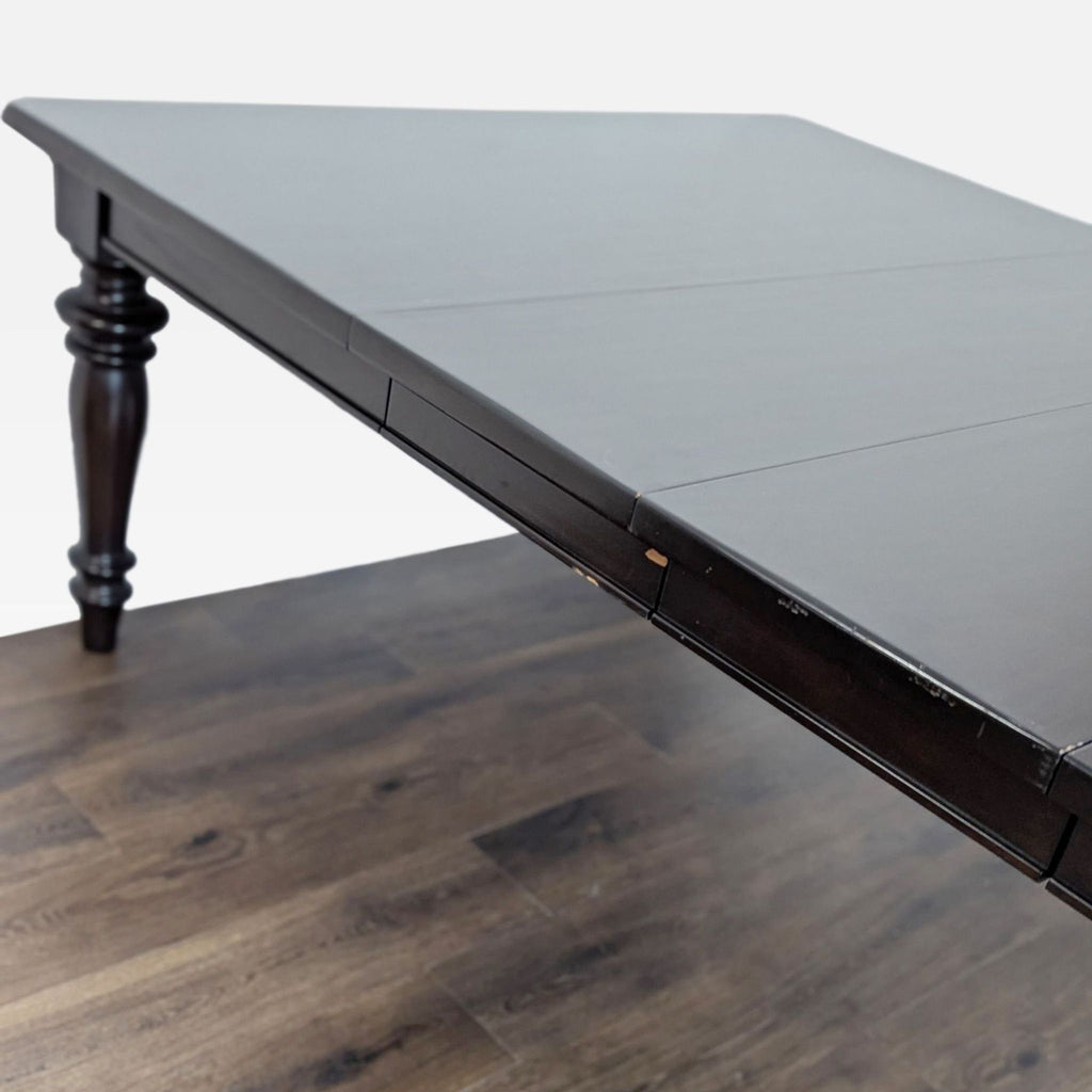 3. Close-up of the corner of a Reperch dining table, highlighting the extension leaf seams and wood texture.