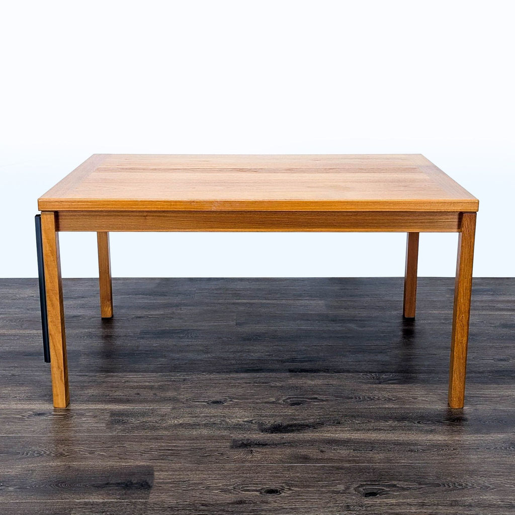 1. Rectangular Reperch dining table shown without leaves, measuring 55 inches, on a dark wood floor.  