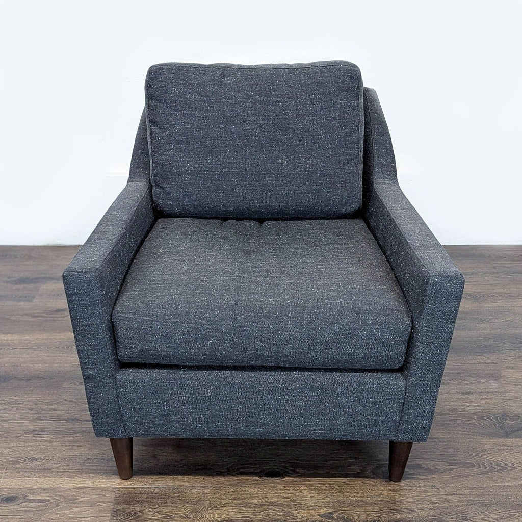 1. Front view of a dark gray West Elm lounge chair, featuring boxy arms and tapered wooden legs, 32.5"w x 33"d x 33"h.