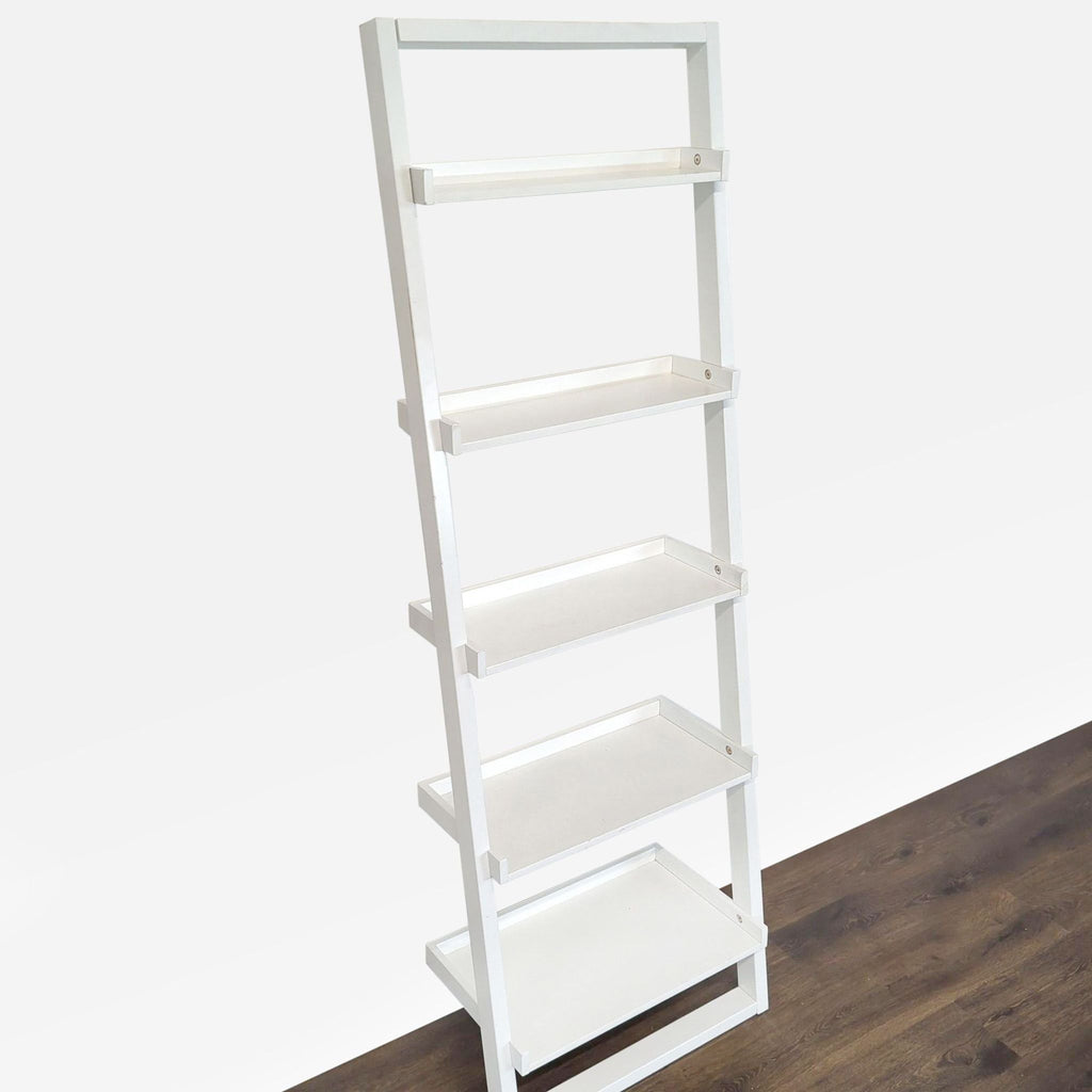 2. Angled view of a Reperch white bookshelf with five open shelves, leaning against a floor surface.