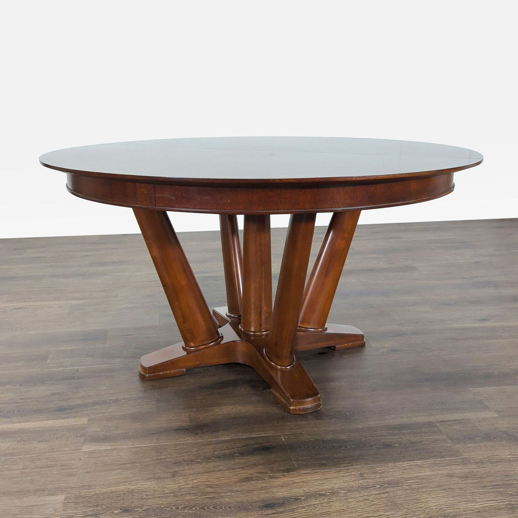 3. Round wooden dining table with four angled central legs, Mitchell Gold + Bob Williams brand.