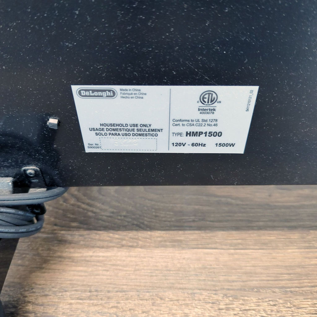 Close-up of the DeLonghi heater label, displaying model HMP1500, 1500W power, and household use details.