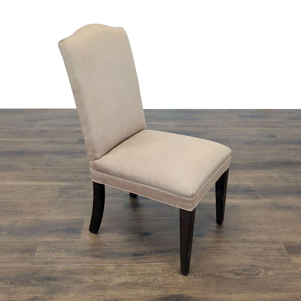 3. Full view of a taupe upholstered dining chair with dark wood legs, from Mitchell Gold + Bob Williams.