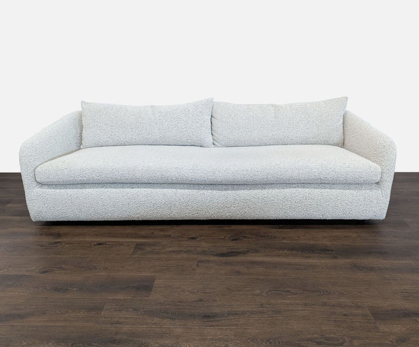 1. Modern 3-seat Four Hands sofa with rounded edges and angled arms, upholstered in textured boucle fabric, front view.