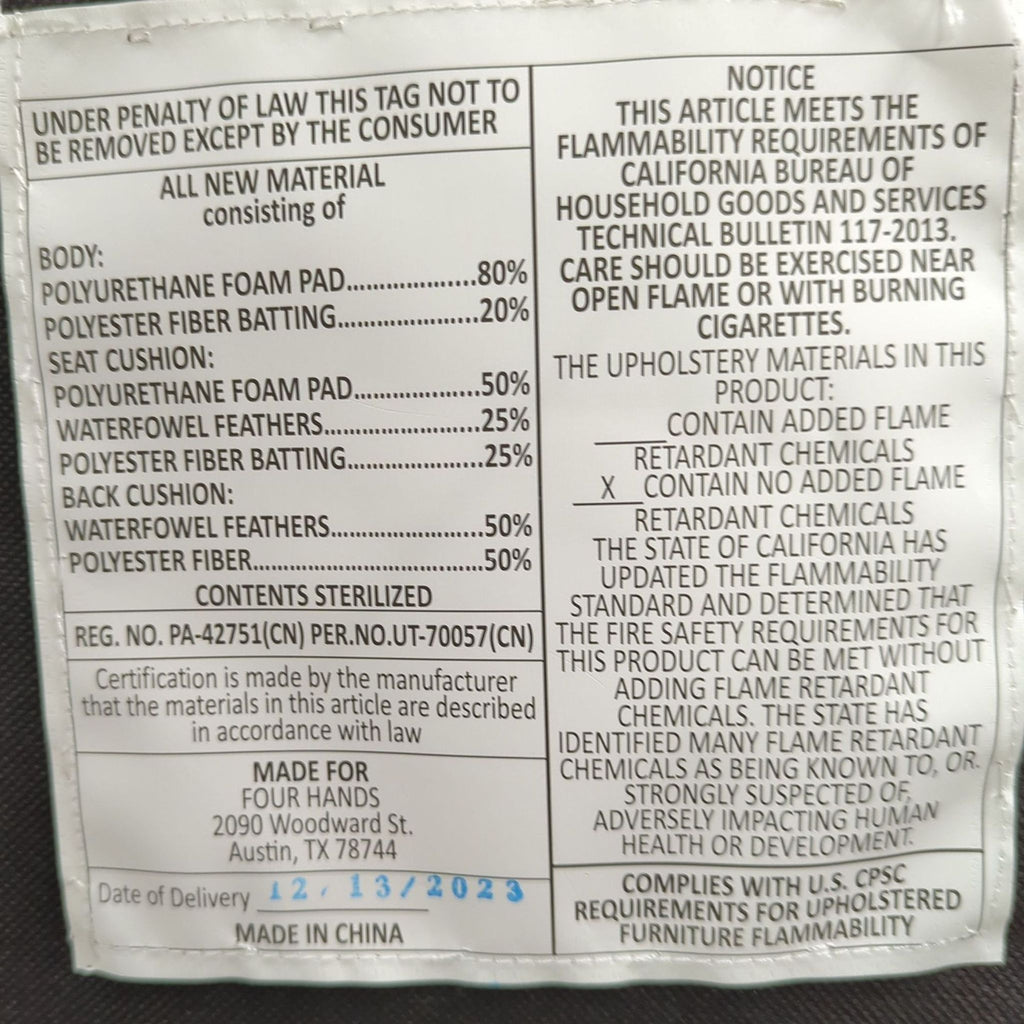 1. Close-up of a product label for a Four Hands 3-seat sofa showing material composition and flammability details.