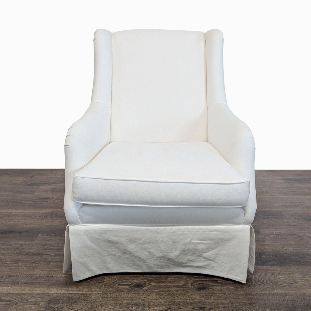 Ethan Allen lounge chair with white fabric, cushioned seat, curved arms, and tailored skirt in modern style.  