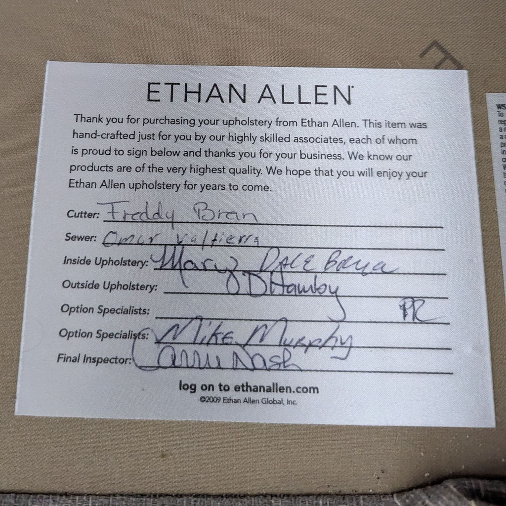 3. Close-up of Ethan Allen upholstery tag showing craftspeople signatures and quality assurance for a 3-seat sofa.