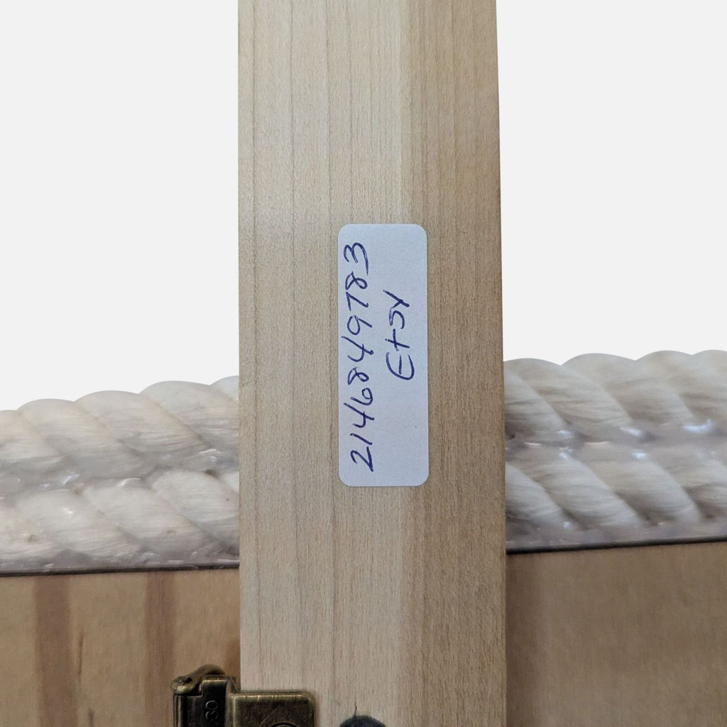 3. Detail of a wooden art panel with a handwritten label reading "2146849783 ETSY" beside attached white rope.