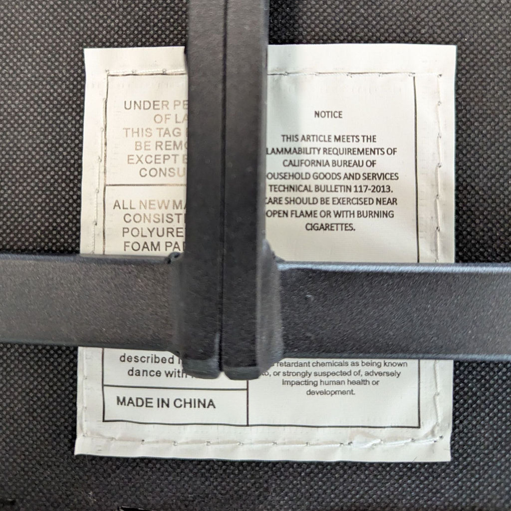 1. Close-up of the Reperch stool's tag showing material, fire safety information, and "Made in China" label.