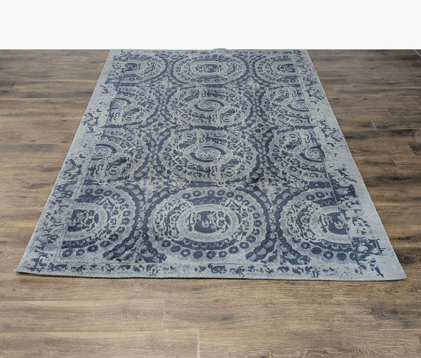 1. Pottery Barn wool rug with vintage-inspired vanishing medallion pattern on a wood floor.