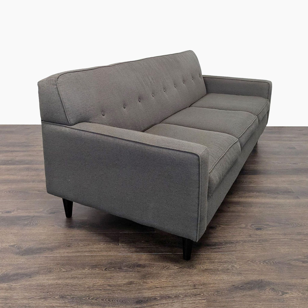 2. Angled side view of Max Home Furniture 3-seat sofa featuring piped trim, tufted back, and wood legs.  