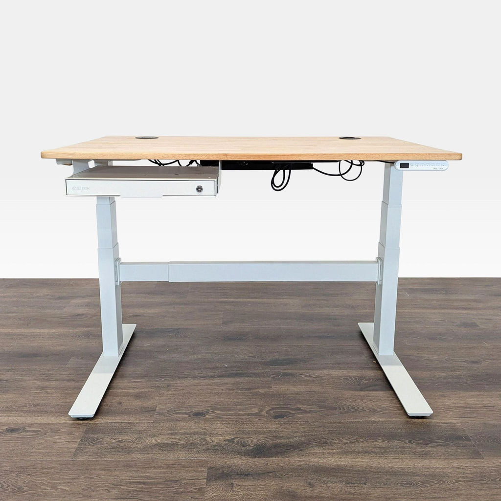 1. Uplift sit-stand desk with a light wood top, white frame, cable management, and under-desk storage on a dark floor.  
