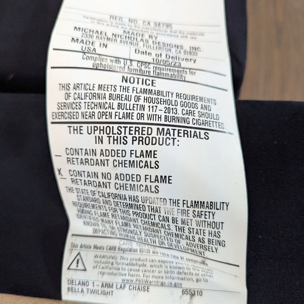 1. Product tag showing safety information for Living Spaces Delano 1-arm sectional, no added flame retardant chemicals.
