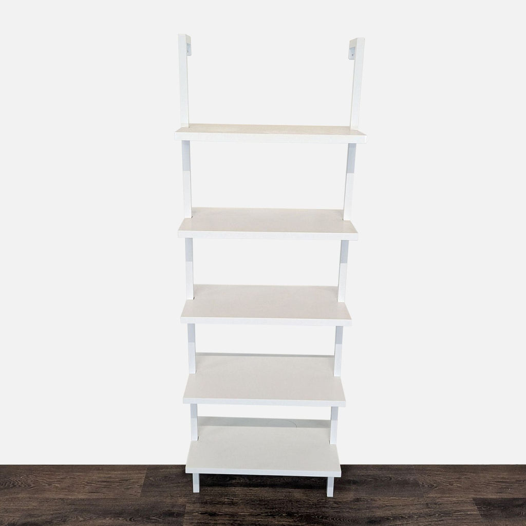 Wall-mounted white bookshelf with five fixed painted laminate shelves by Nathan James, viewed from the front.  