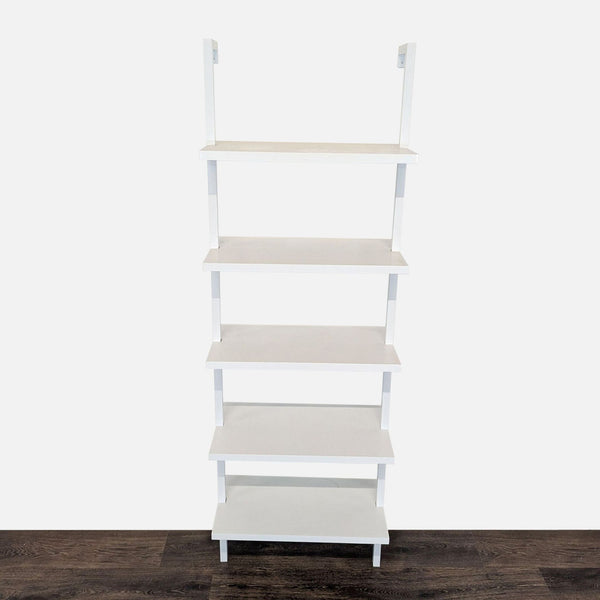 Wall-mounted white bookshelf with five fixed painted laminate shelves by Nathan James, viewed from the front.  