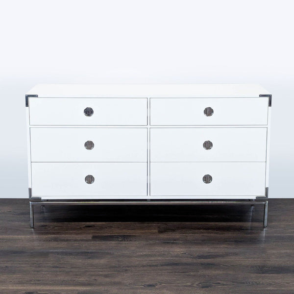 1. White West Elm dresser with six drawers, metal hardware, and corner brackets on dark wood floor.