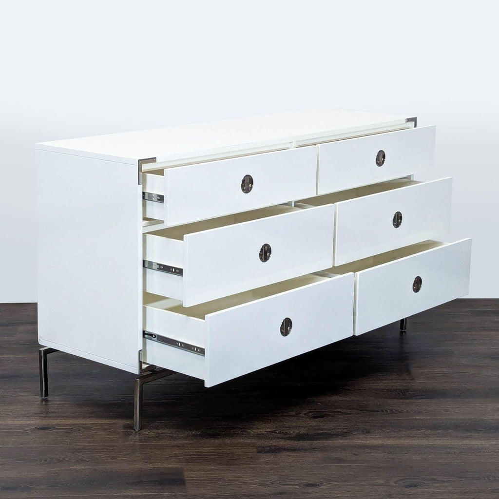 3. West Elm white dresser with all six drawers open, showing spacious storage and chrome hardware accents.