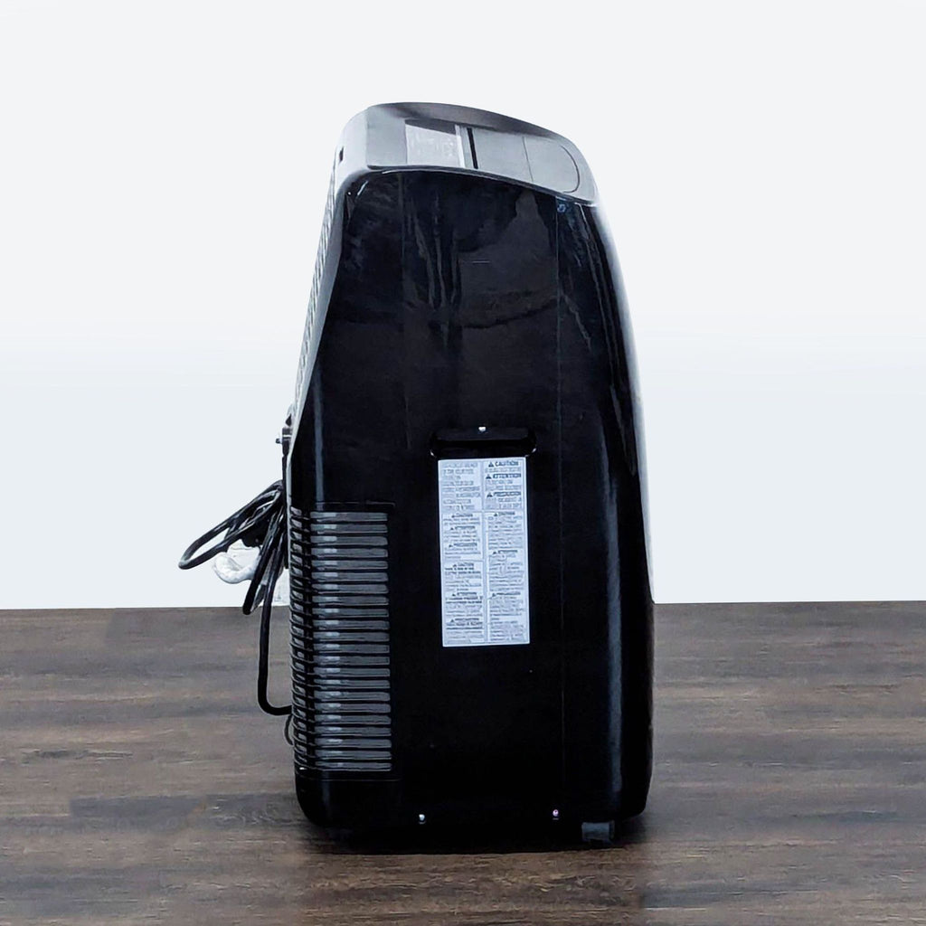 3. Rear side view of an LG portable AC unit with visible venting, compact build, and informative label.
