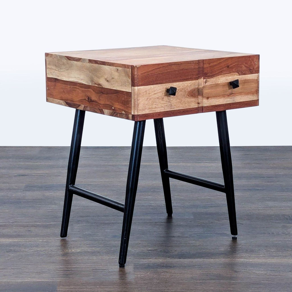 3. Angled view of Reperch End Table by Reperch, featuring dual drawers and sturdy black legs.