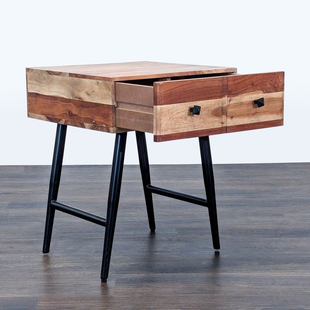 2. Side view of Reperch End Table, showing an open drawer, wood grain finish, and black metal legs.  