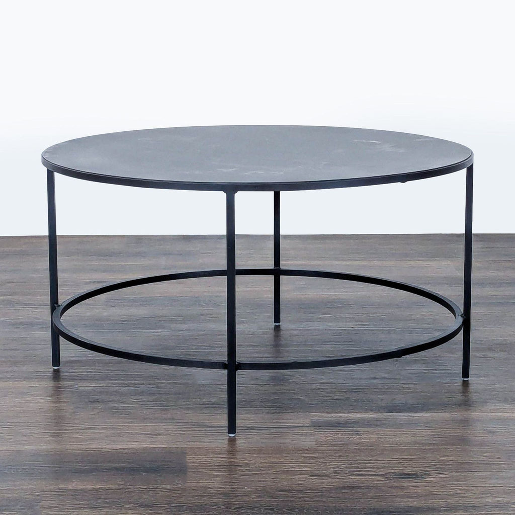 2. Modern slate-finish coffee table by Room & Board, constructed from powder coated steel with circular support.  