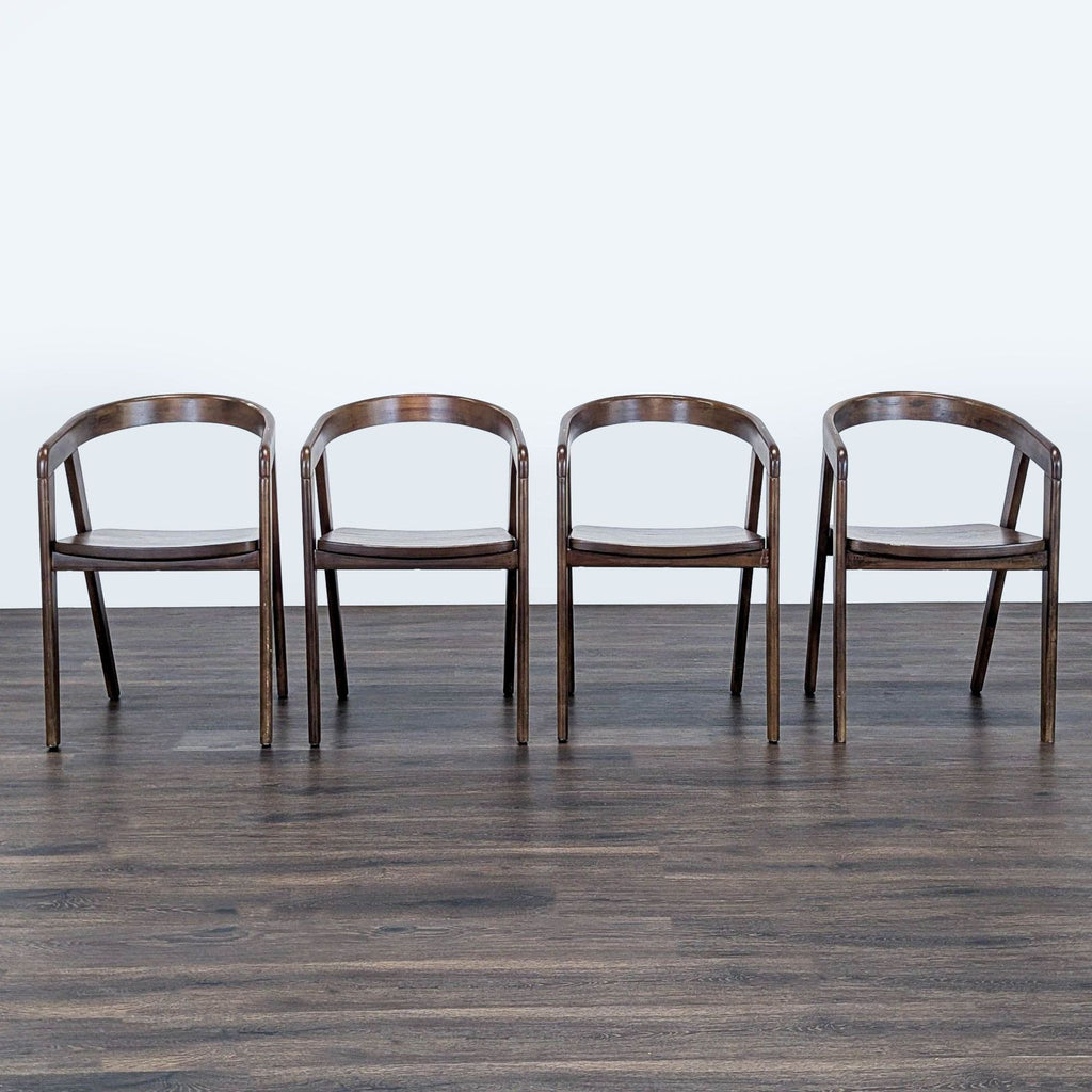 Set of four Reperch dining chairs with curved wooden backrests and dark finishes, arranged in a row.