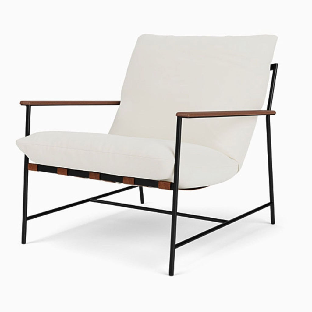 3. Angled view of a Denver Modern lounge chair, featuring white upholstery, black frame, and wooden accents on the arms.