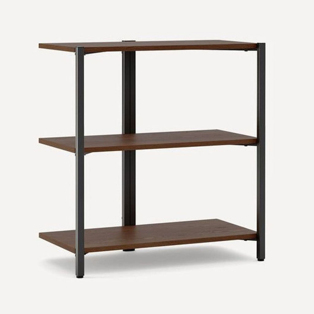 Angled view of a Burrow three-shelf bookshelf in dark wood with a sturdy black metal frame, suitable for any room.
