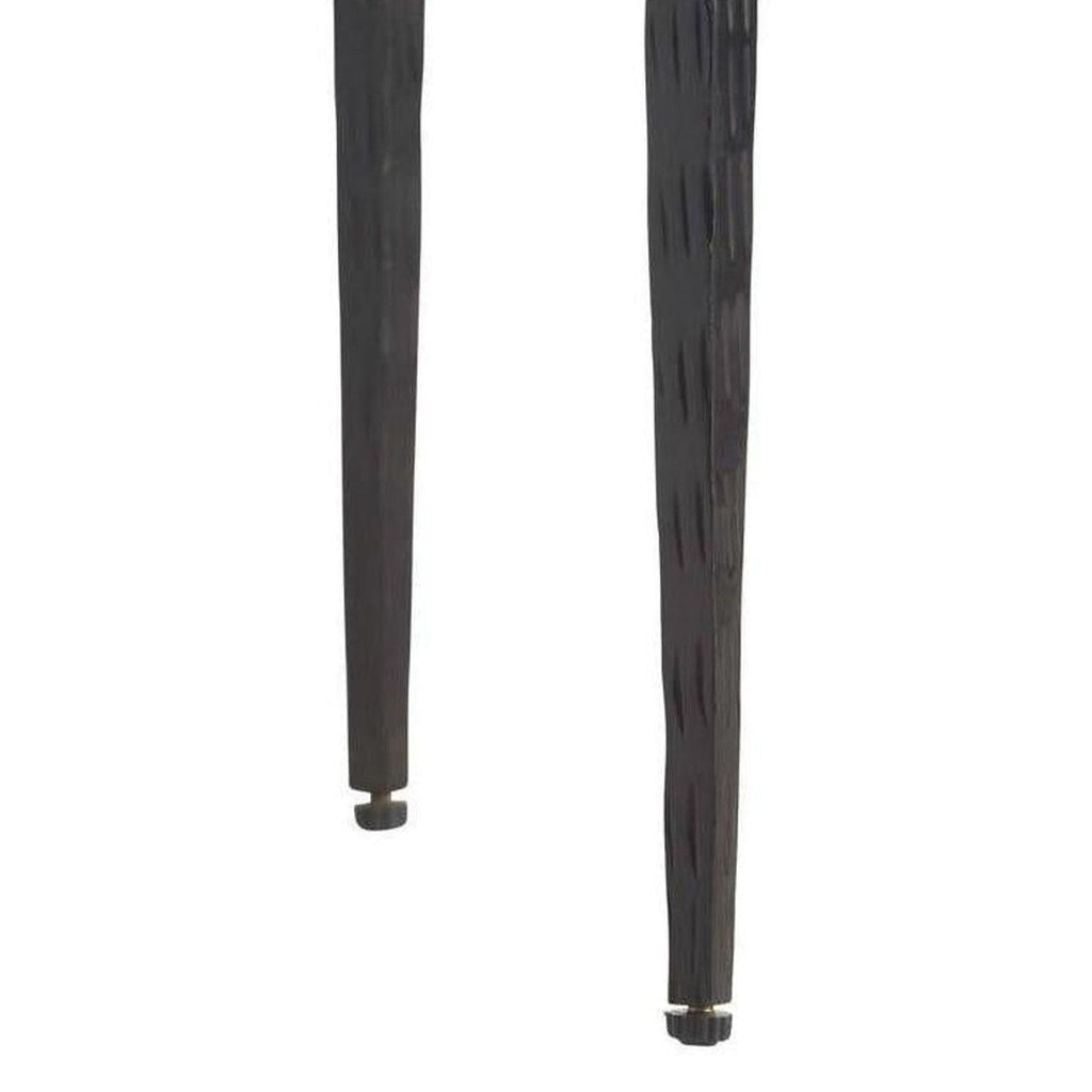 3. Detailed look at the tapered metal legs of an Arteriors Home lounge chair in the Lounge category.