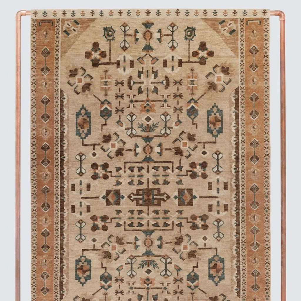 Handwoven rug by The Citizenry featuring intricate geometric and floral patterns in earthy tones and border detailing.