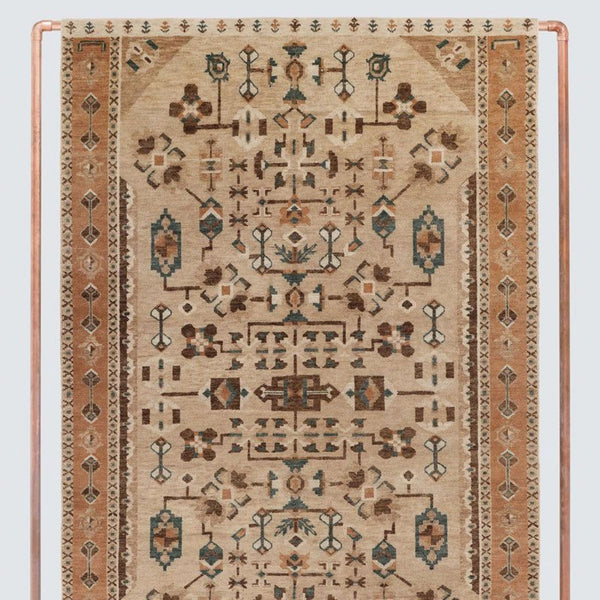 Handwoven rug by The Citizenry featuring intricate geometric and floral patterns in earthy tones and border detailing.