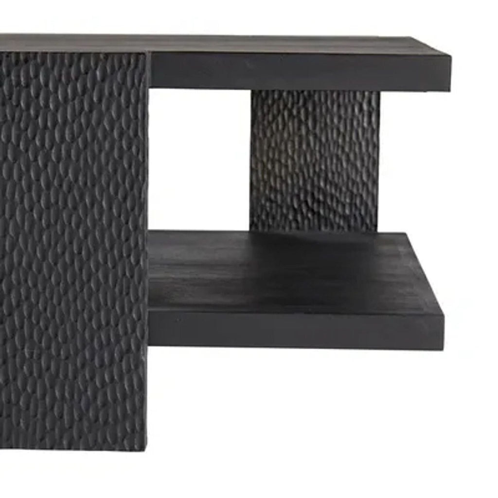 3. Detailed view of the textured, wire-brushed carved support and shelf of the Aiden black coffee table.