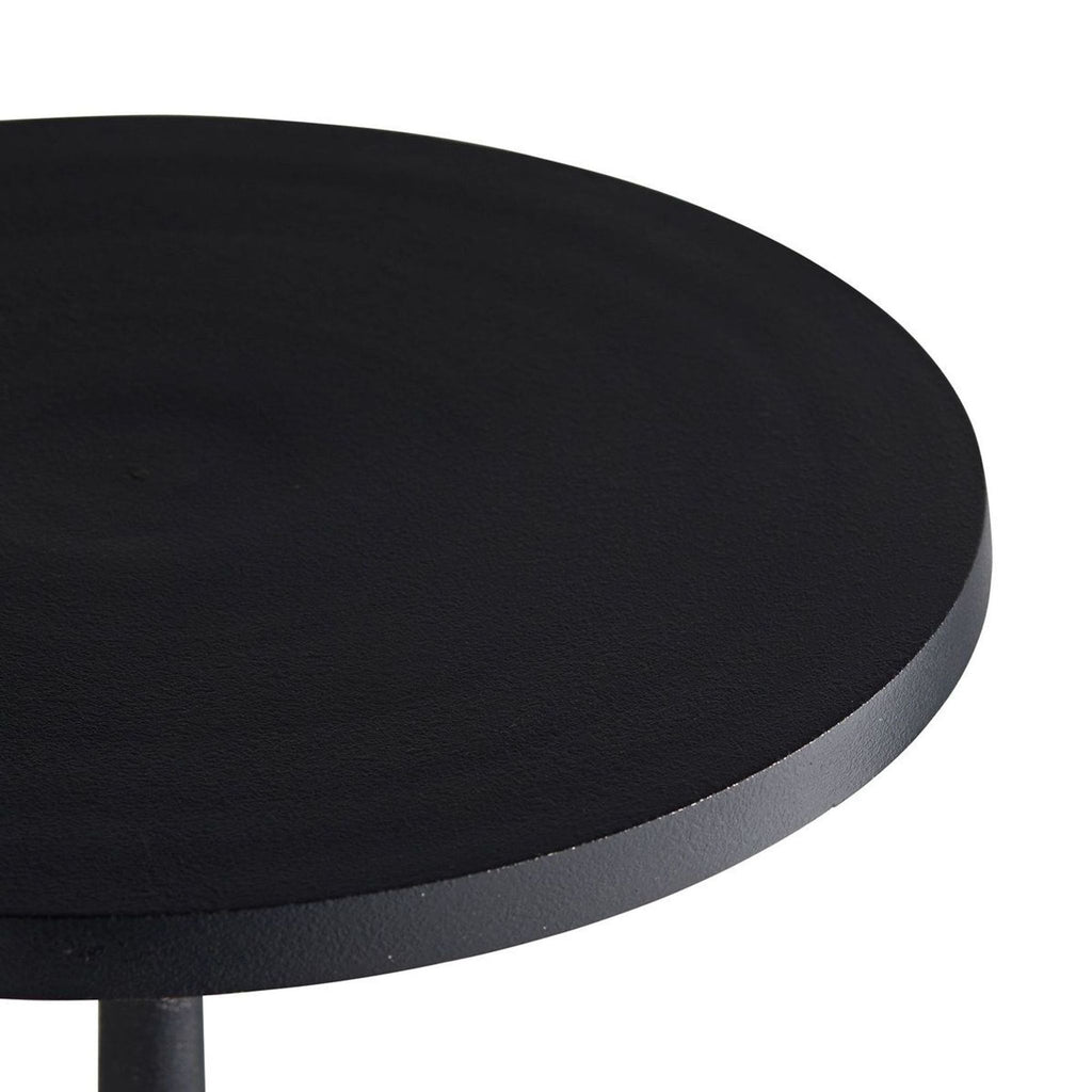 2. Close-up of a round, charcoal-finished tabletop crafted from cast aluminum by Arteriors Home.