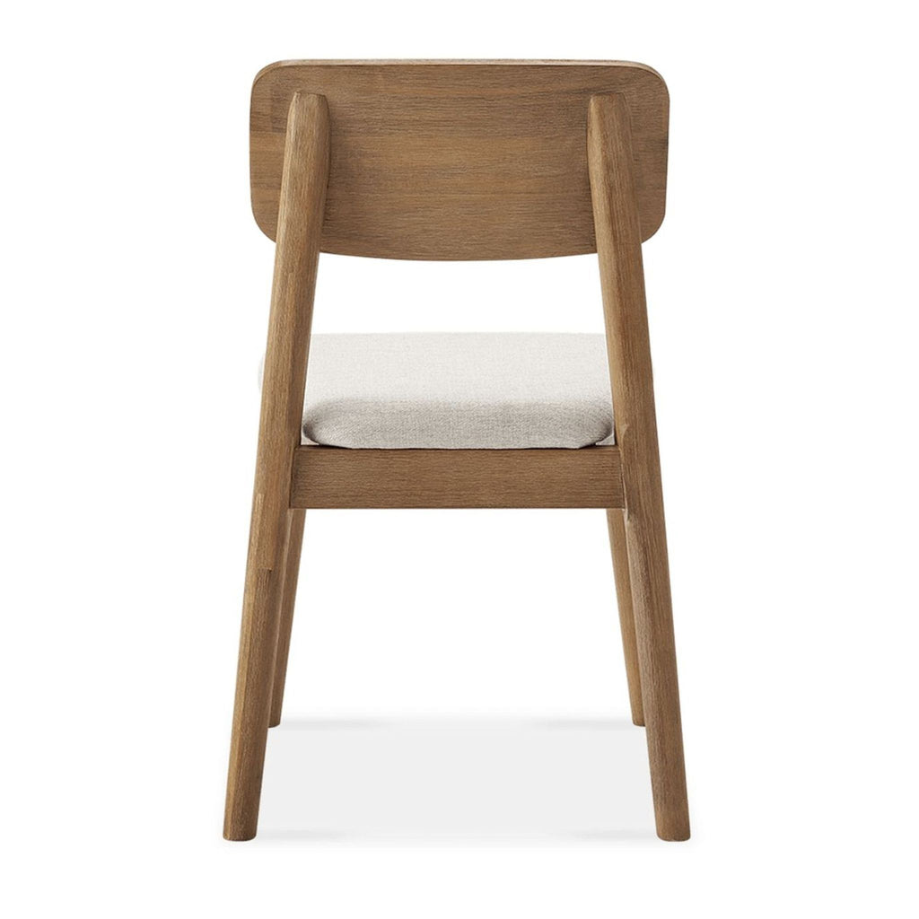 2. Rear view of Castlery dining chair featuring solid acacia wood and upholstered seat in neutral fabric.  