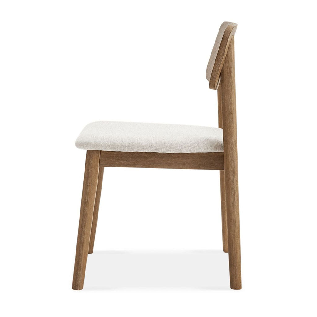 Side view of Castlery dining chair showing wood frame and cushioned upholstered seat in light fabric.  