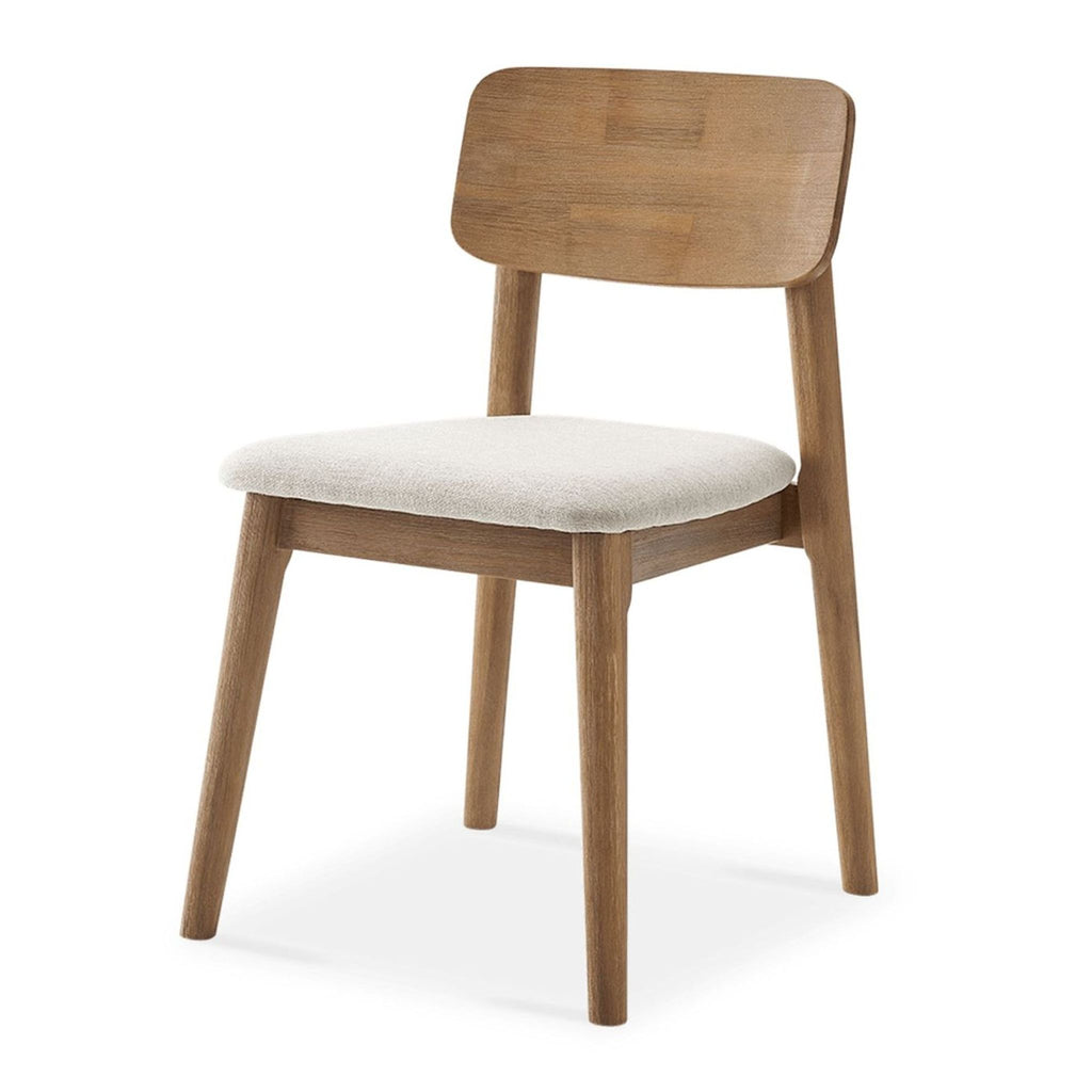3. Angled side view of the Castlery dining chair, showing its sturdy wood build and soft upholstered seat.