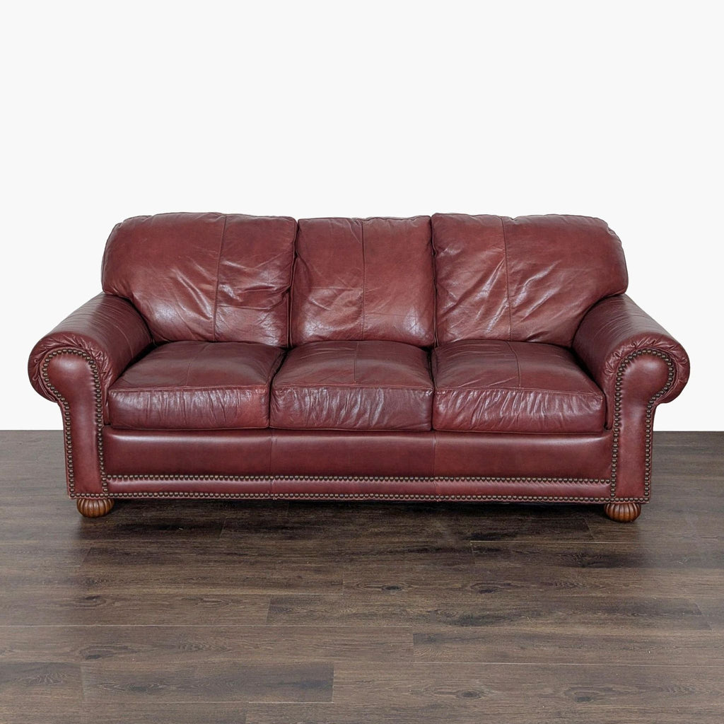 1. Front view of a Viewpoint Leather Works 3-seat sofa in rich brown leather with rolled arms and nailhead trim.  