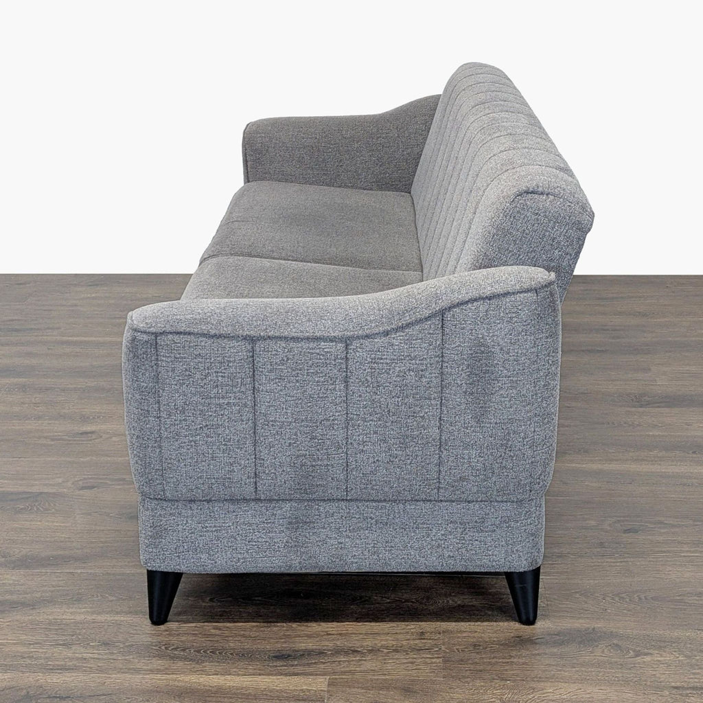 3. Side view of the Reperch grey 3-seat sofa, showing its sleek profile and comfortable padding.